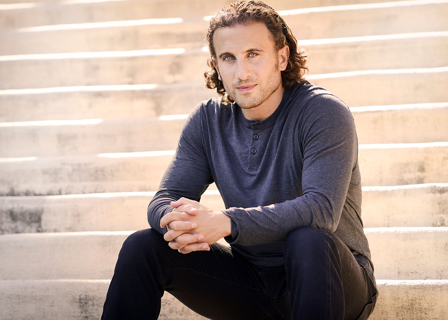 Chris Bashinelli sitting on cement steps
