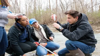 Professor working with science students