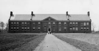 A early view of Mason Hall alone in the field off Central Ave.